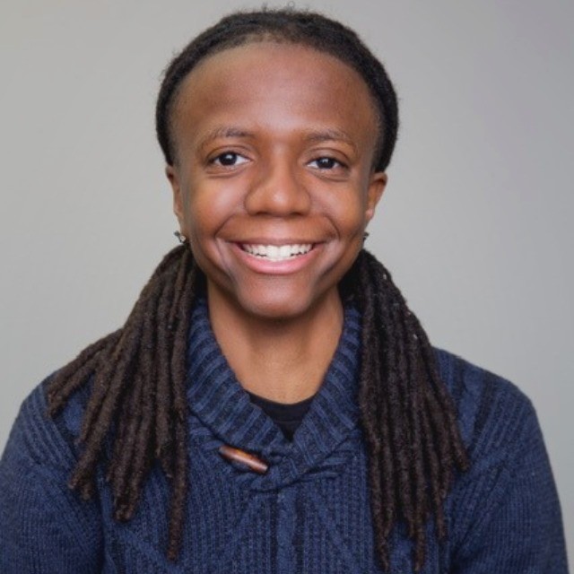 Smiling woman with warm expression, natural light background