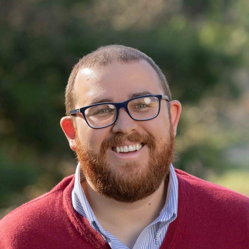 Professional man with calm demeanor, neutral background
